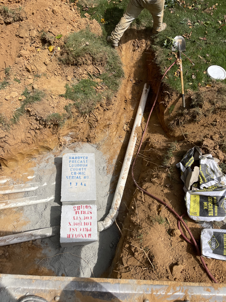 Installation of septic system components in a trench with piping work