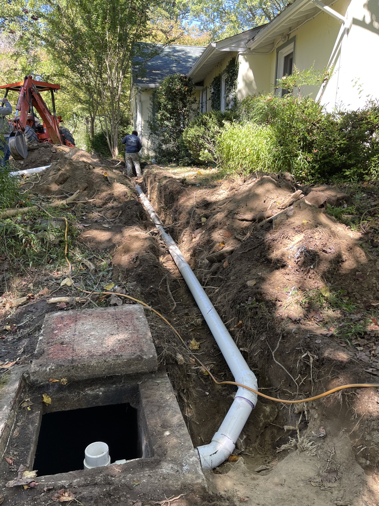 Septic system drain line replacement and excavation work in progress.