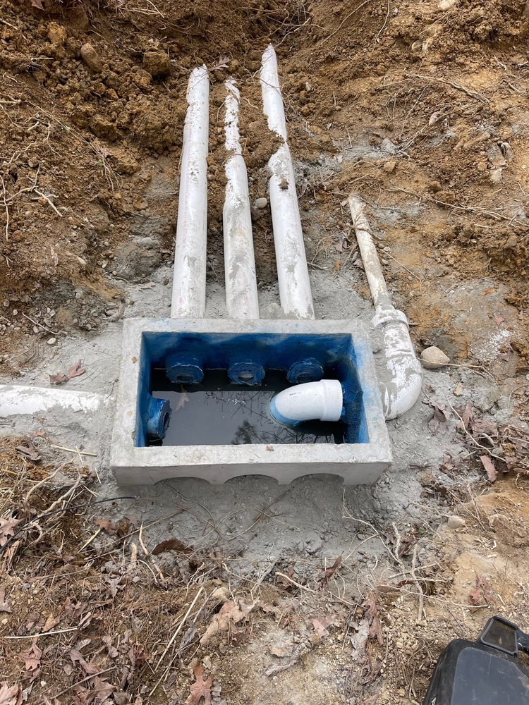 Septic tank installation with inlet pipes connected to the distribution box.