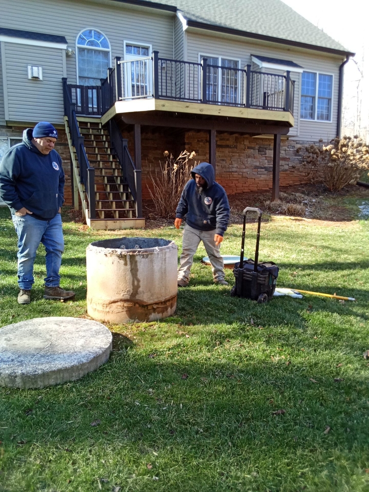 A technician performing a routine septic system inspection