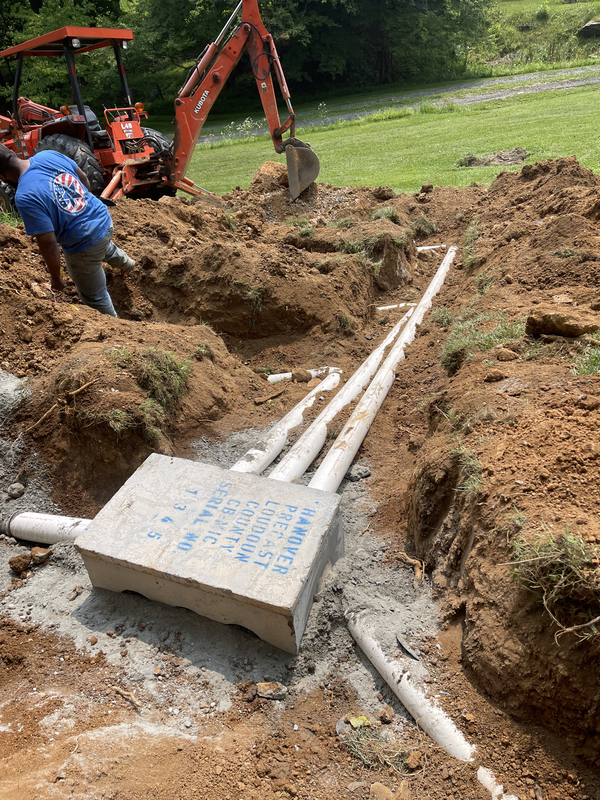 Septic system pipes and concrete tank installation