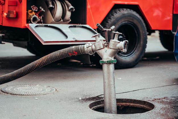 Industrial septic pumping in progress using specialized hose and equipment