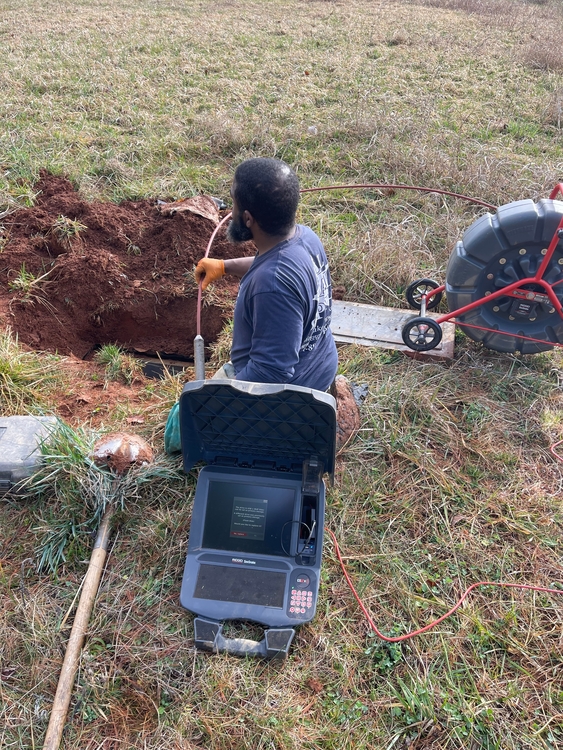 Inspector conducting a thorough septic tank examination with advanced tools