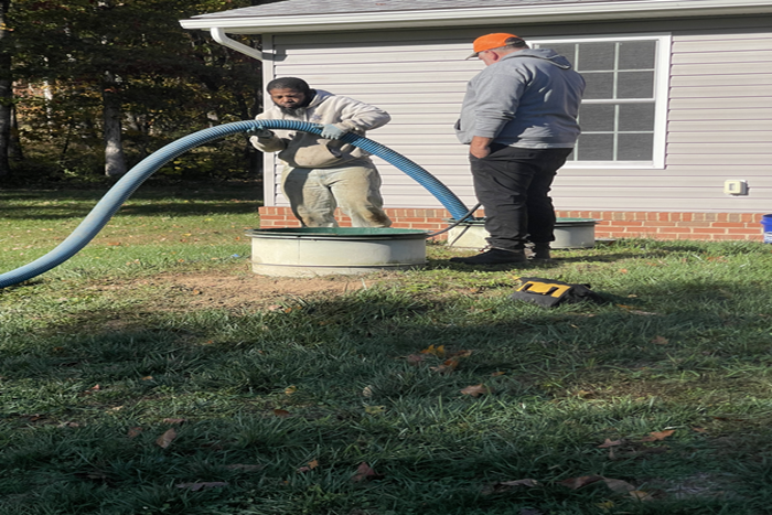 Experts performing sewer line clog repair using high-pressure hoses