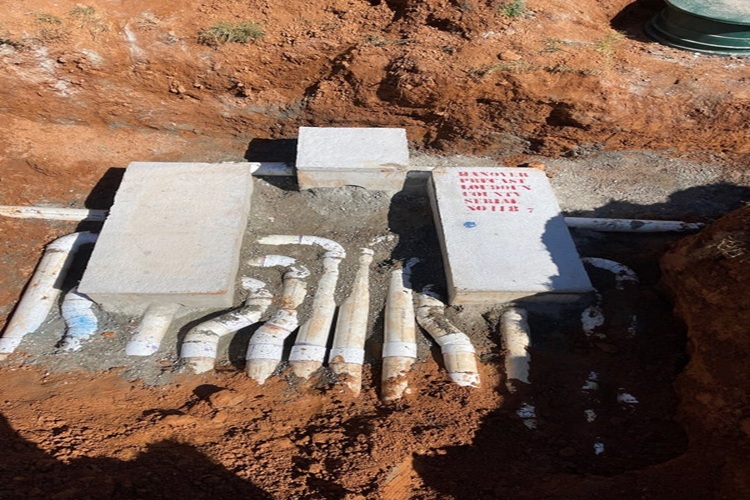Cracked septic distribution box repaired with new PVC pipes