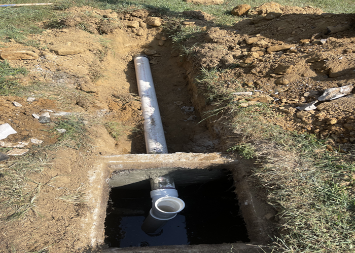Connecting new pipe to septic system during drain field repair