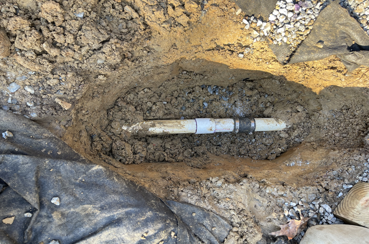 PVC pipe connection buried in soil during septic repair work