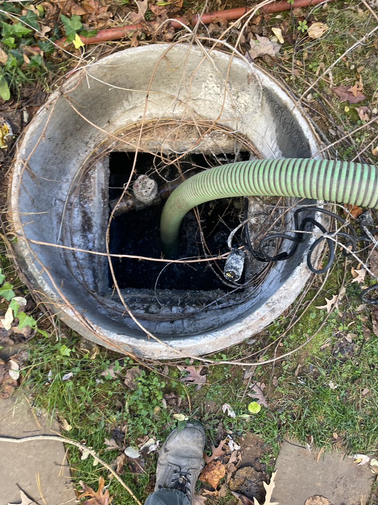 Biannual septic tank pumping using green hose for waste removal